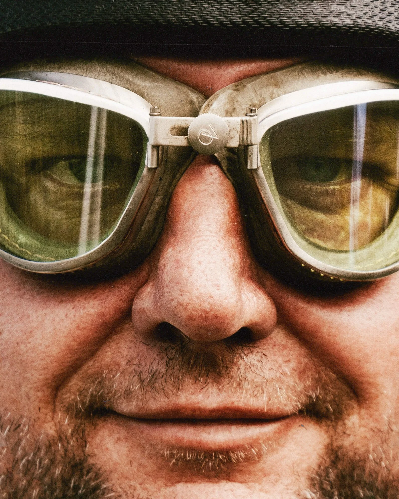 Close-up of a person's face with glasses, showing the nose and part of the upper lip, with facial hair.