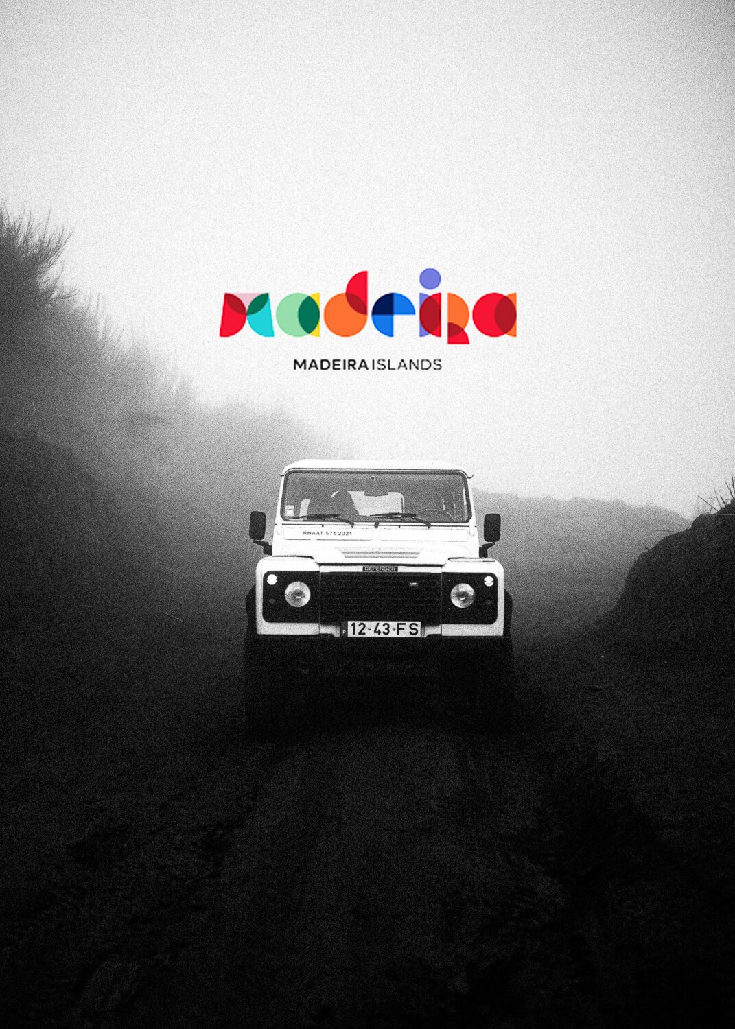 Black and white photograph of a Land Rover driving on a dirt road surrounded by foggy landscape. Colorful logo of Madeira Islands is at the top.