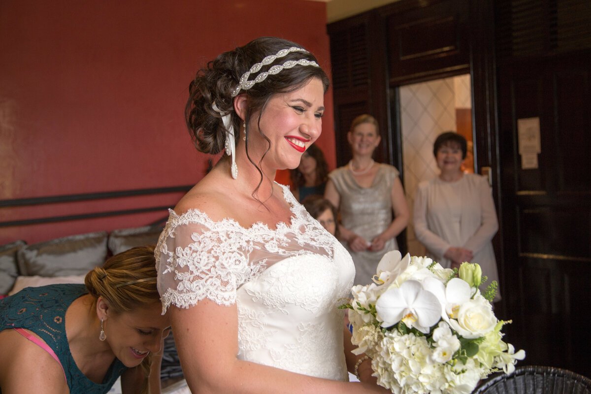 bride-and-white-rose-bouquet-wedding-preparations-wedding-dress-bridal-suite.jpg