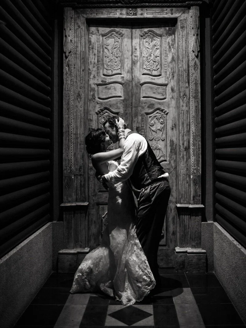 bride-and-groom-kissing-bride-and-groom-retro-hand-carved-wooden-door.jpg