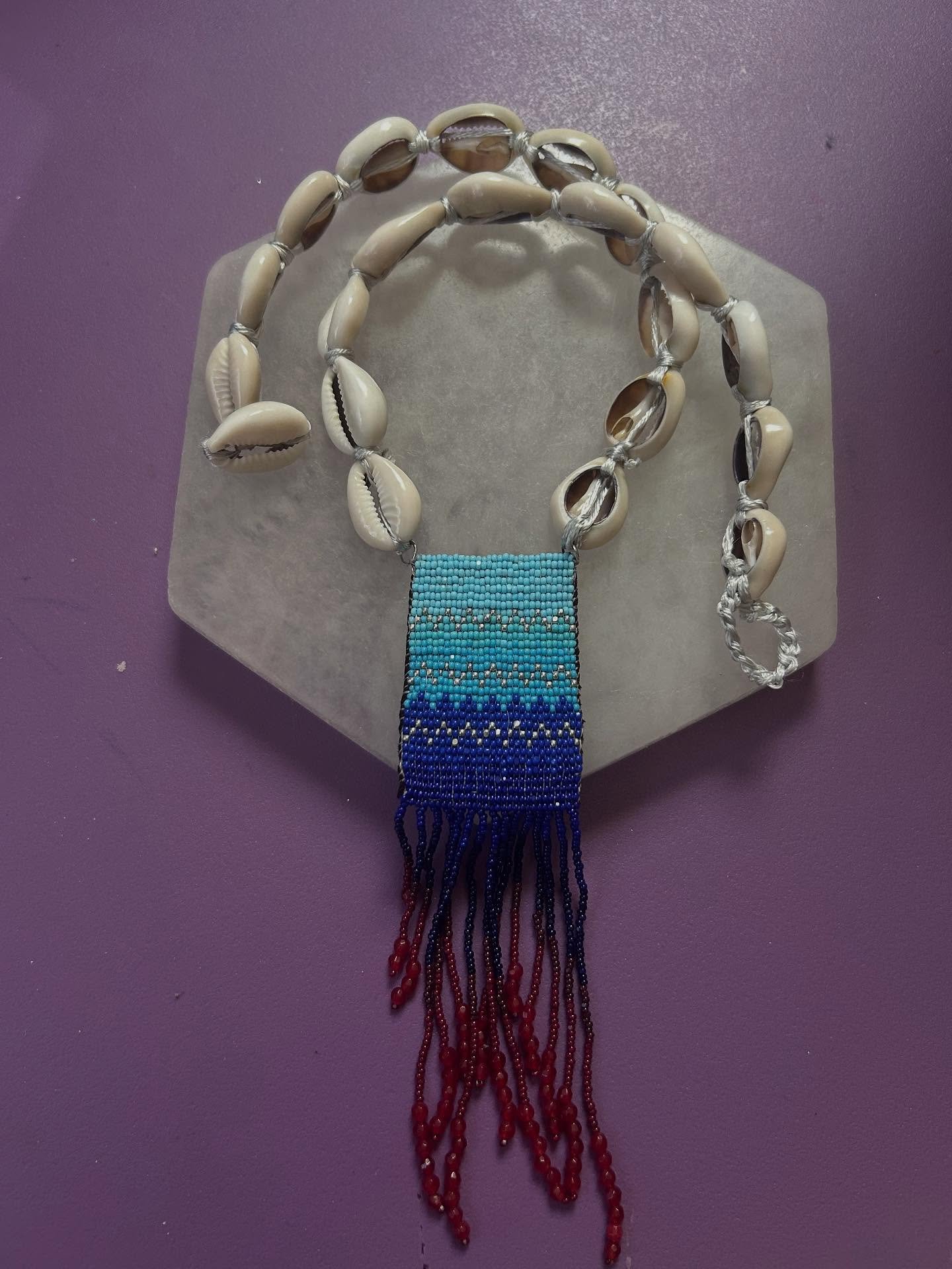 Yes, I still bead. Created this custom gift for my Dr. Sistar. 🌊👩🏽&zwj;🎓

&ldquo;Flow&rdquo;

Charlotte-cut beads on leather, red jade gemstone beads, cowrie shells and silver findings. 

#seshetaweaves #beadwork #explore #flow #water #yemaya #ol