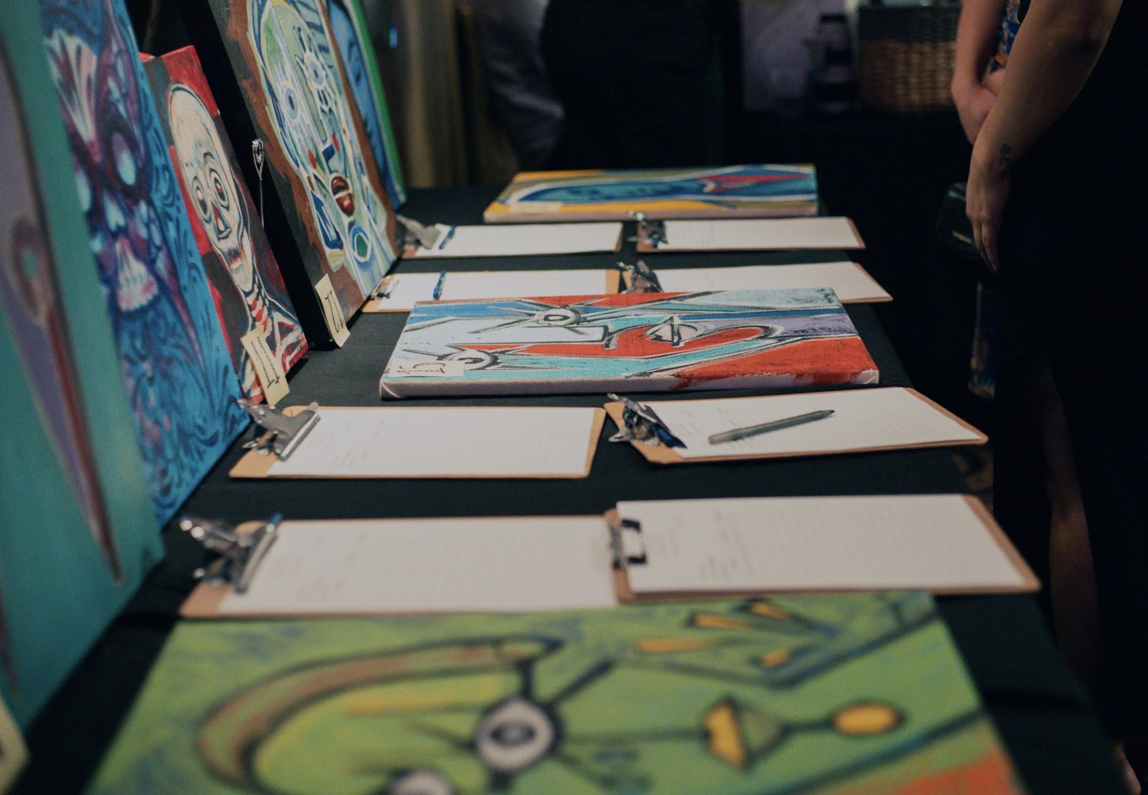   Paintings created by youths listed for a silent auction.   
