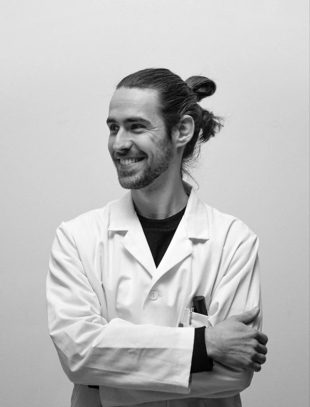 A sculpture of a human head in profile view, with textured surface, supported by a rectangular pedestal.