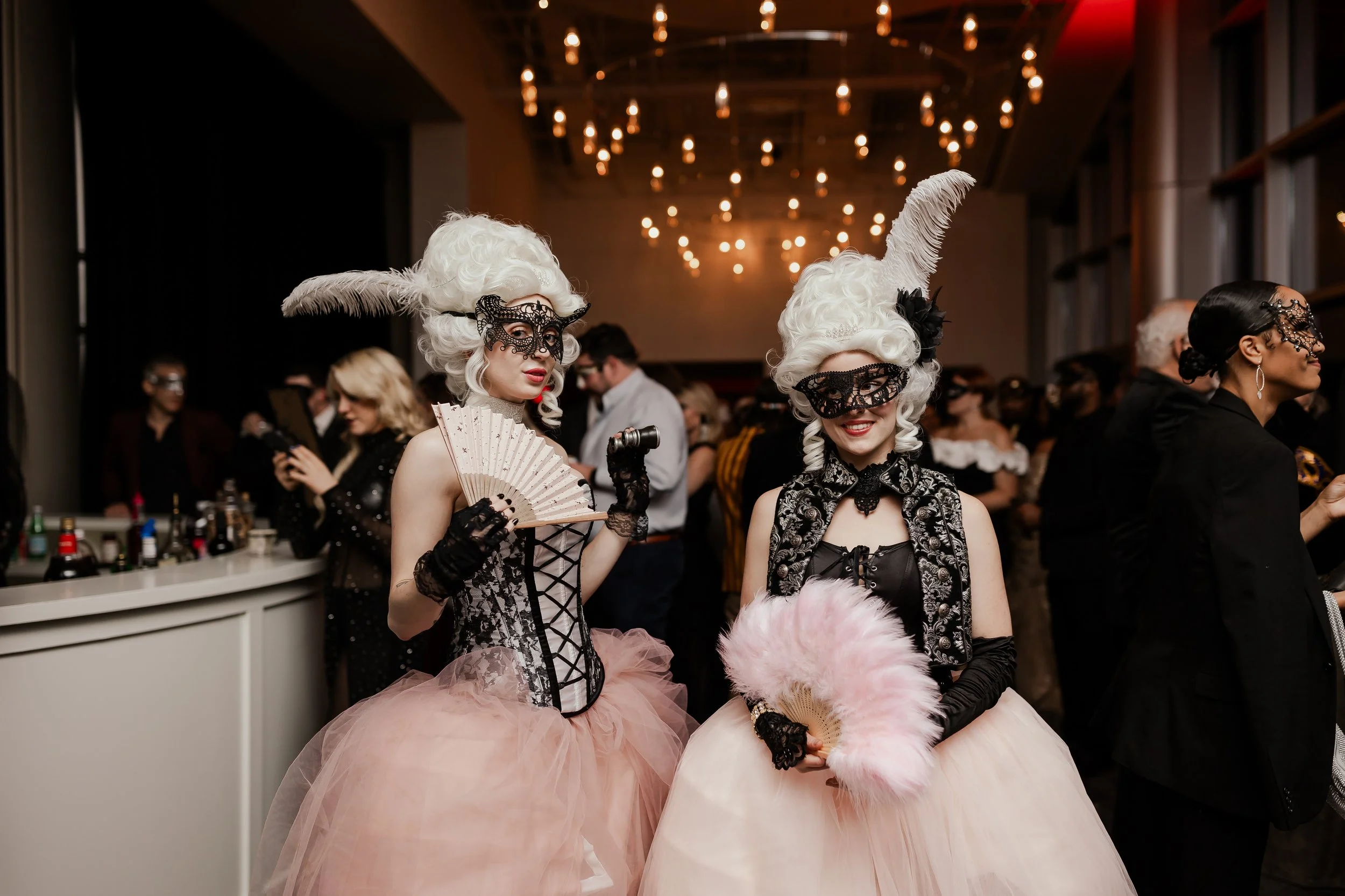 To laldies dressed up in Masquerade costumes at Noah Liff Opera Center