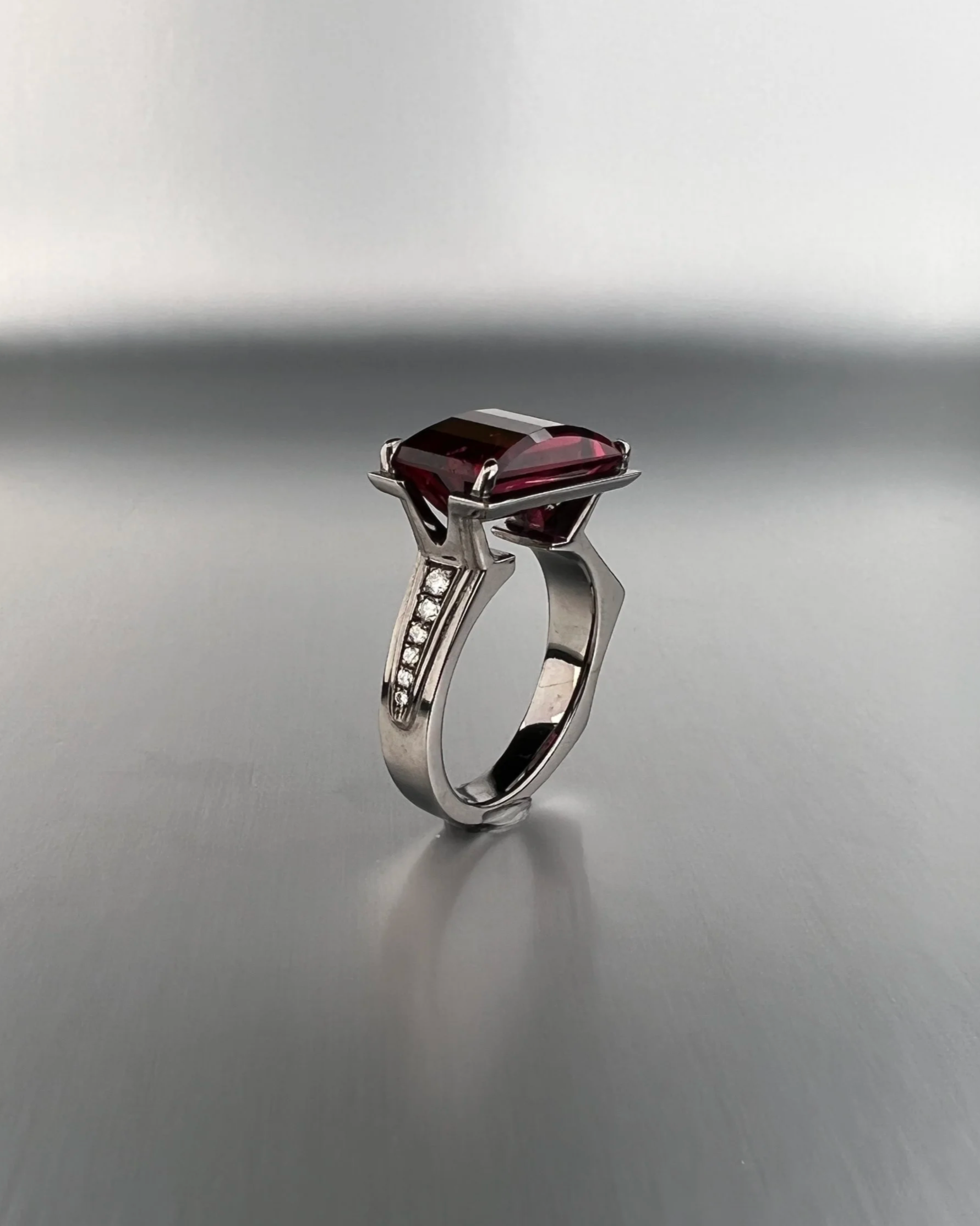 Custom 14k white gold ring featuring a 4.17 ct red tourmaline with natural white diamonds and Argyle pink diamond accents.