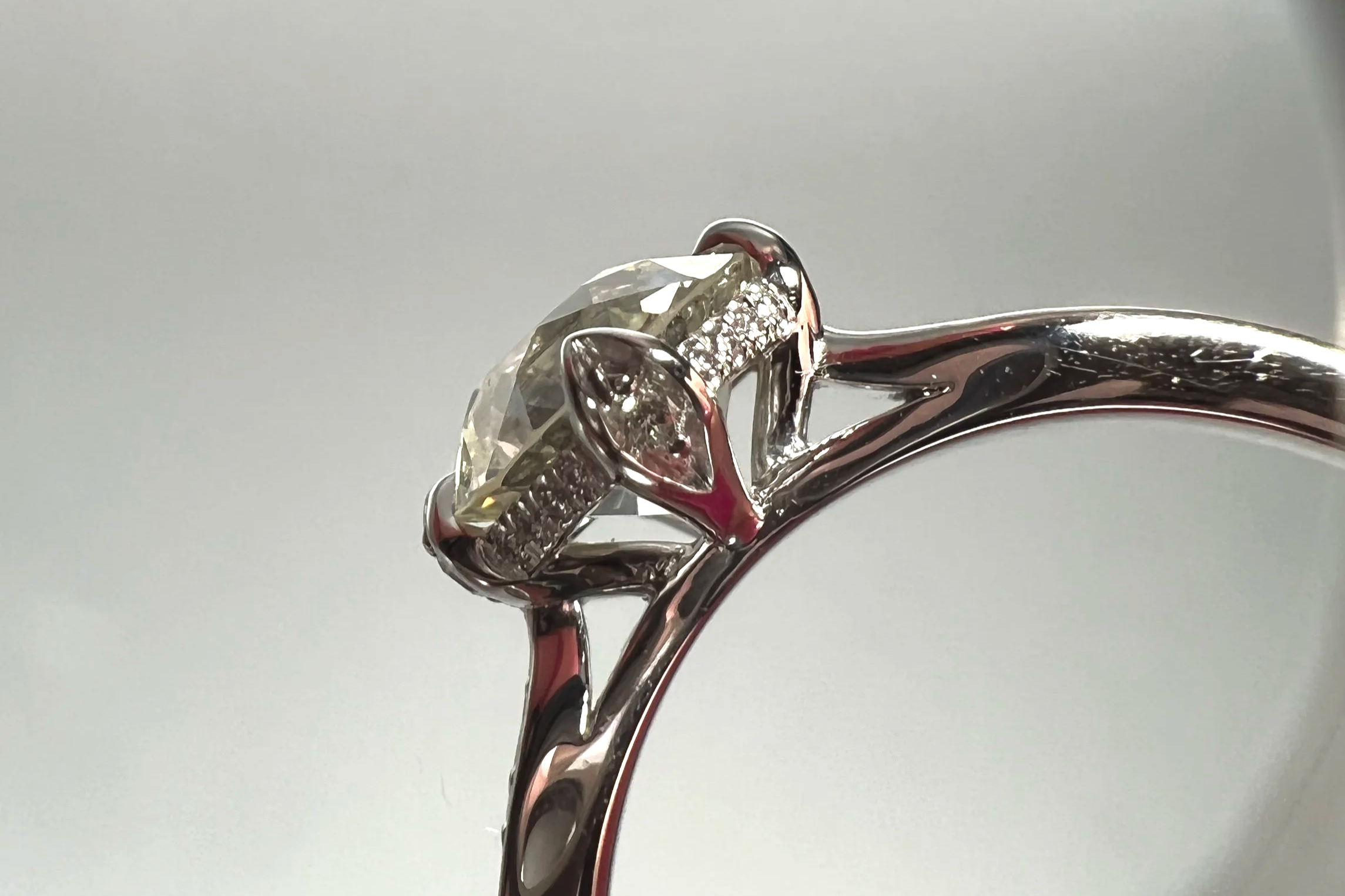 Profile view of a custom platinum engagement ring featuring a 1.39 ct Old European cut natural diamond with pavé single-cut natural diamond accents.