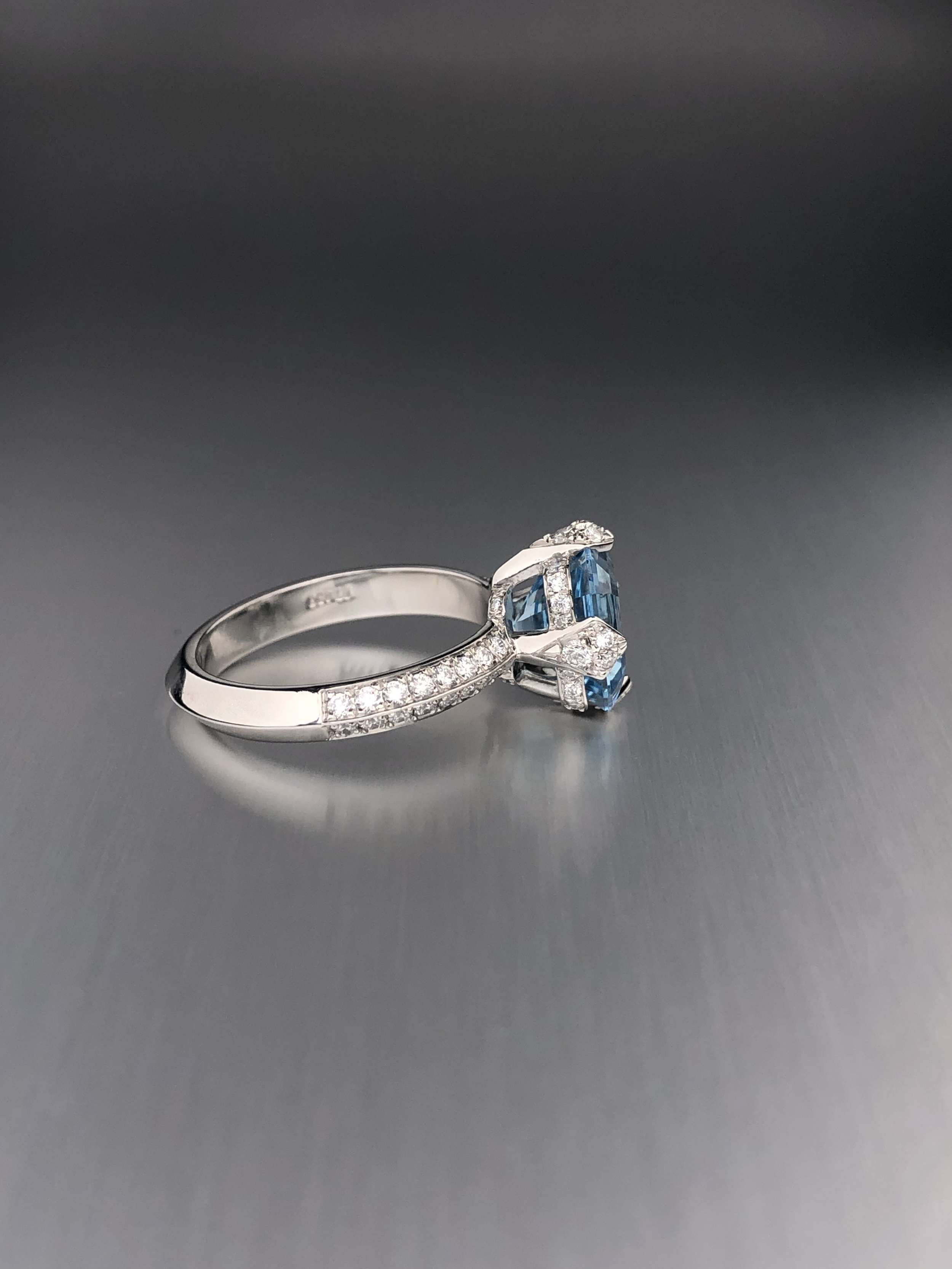 Custom platinum engagement ring featuring a 2.46 ct Asscher-cut aquamarine with natural diamond accents.
