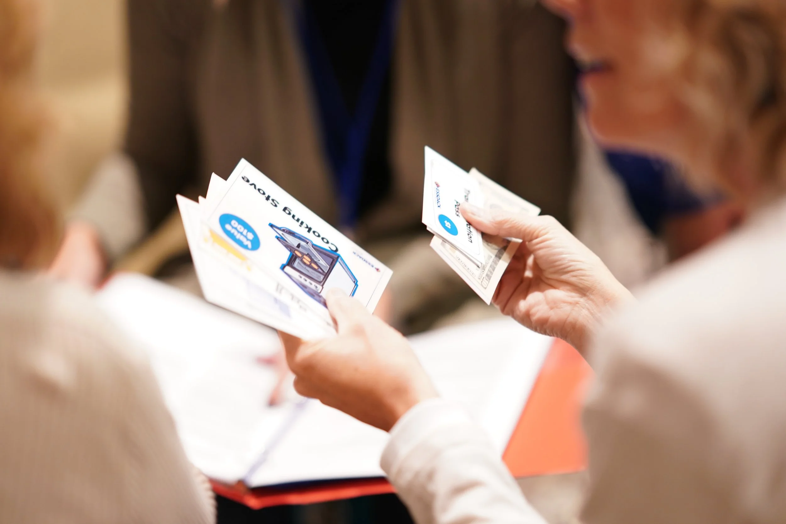 teachers sorting role-playing cards during poverty simulation