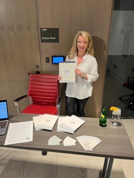 Angela holding book at seminar.jpg