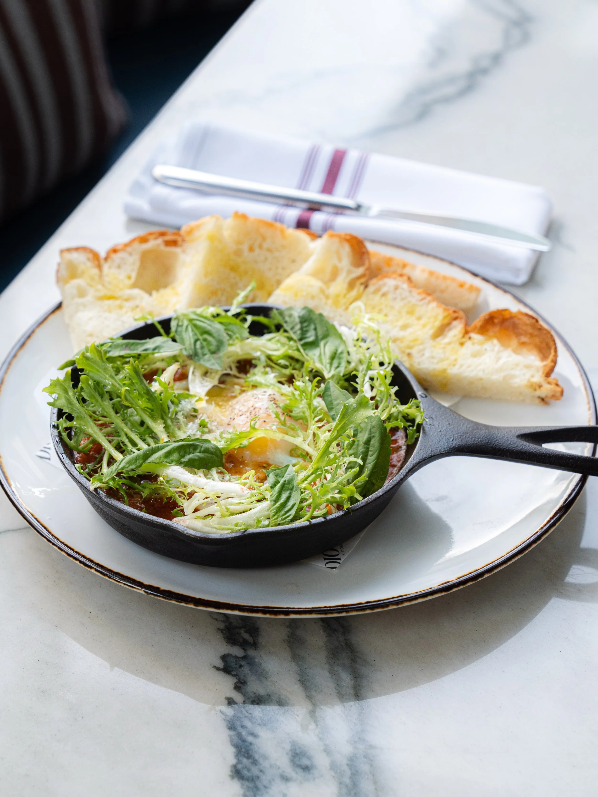 If brunch had a comfort dish, this would be it 🍳

Poached eggs, spicy tomato sauce, fresh basil, crisp greens, and grilled focaccia. It&rsquo;s our Eggs in Purgatory and it&rsquo;s worth waking up for.

Join us Saturdays &amp; Sundays from 11AM&ndas