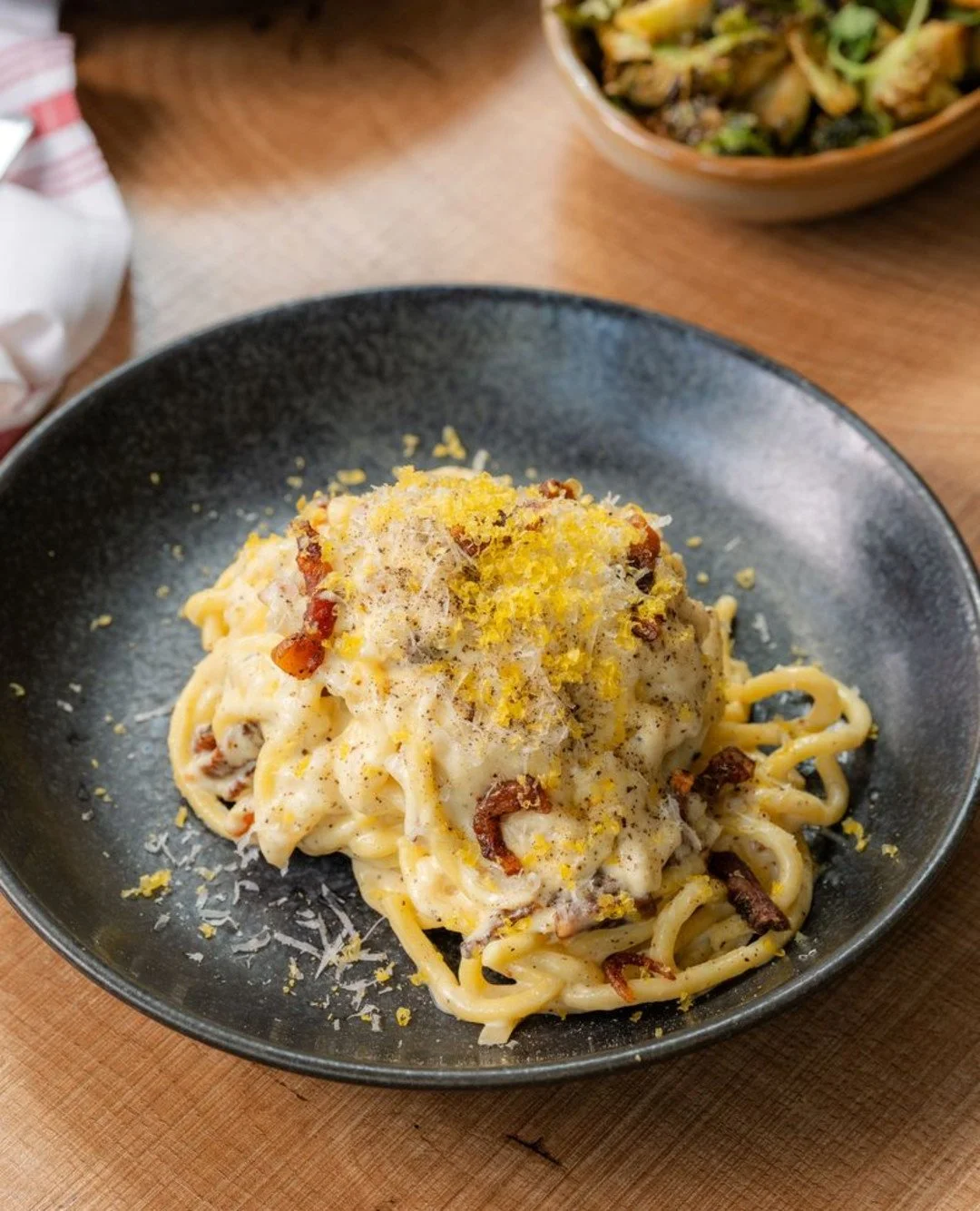 Che bello. Che buono. Che carbonara.

CHITARRA CARBONARA. It's tossed with guanciale, pecorino, cream, and topped with cured egg yolk for the perfect balance of rich, silky, and savoury.