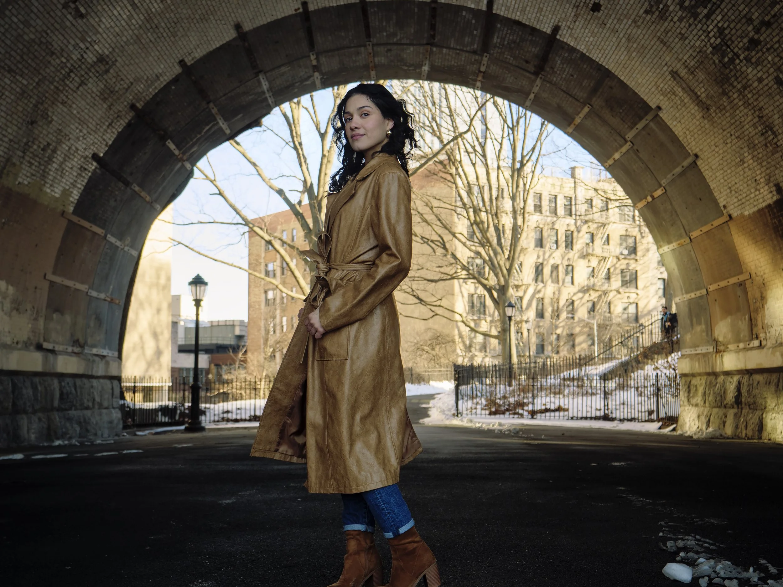Outdoor editorial session with actress Tiffany Iris under a classic stone archway in The Bronx, New York.