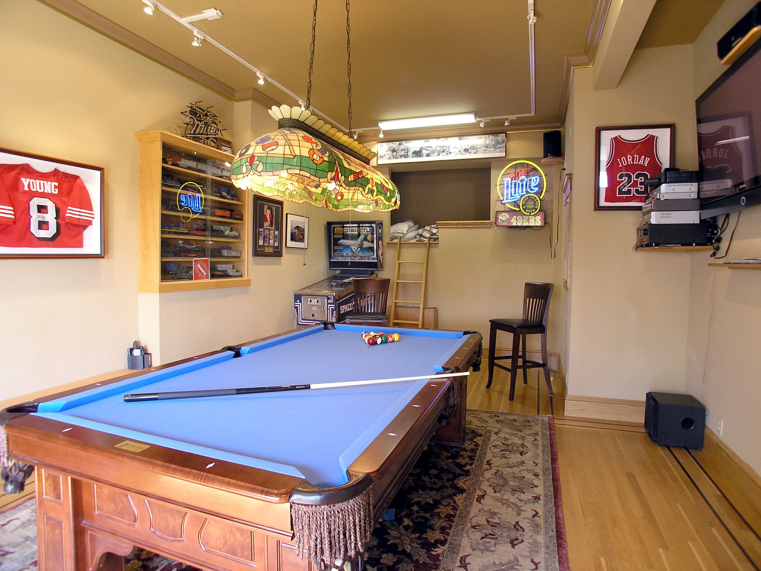 Game room with several wall and ceiling colors
