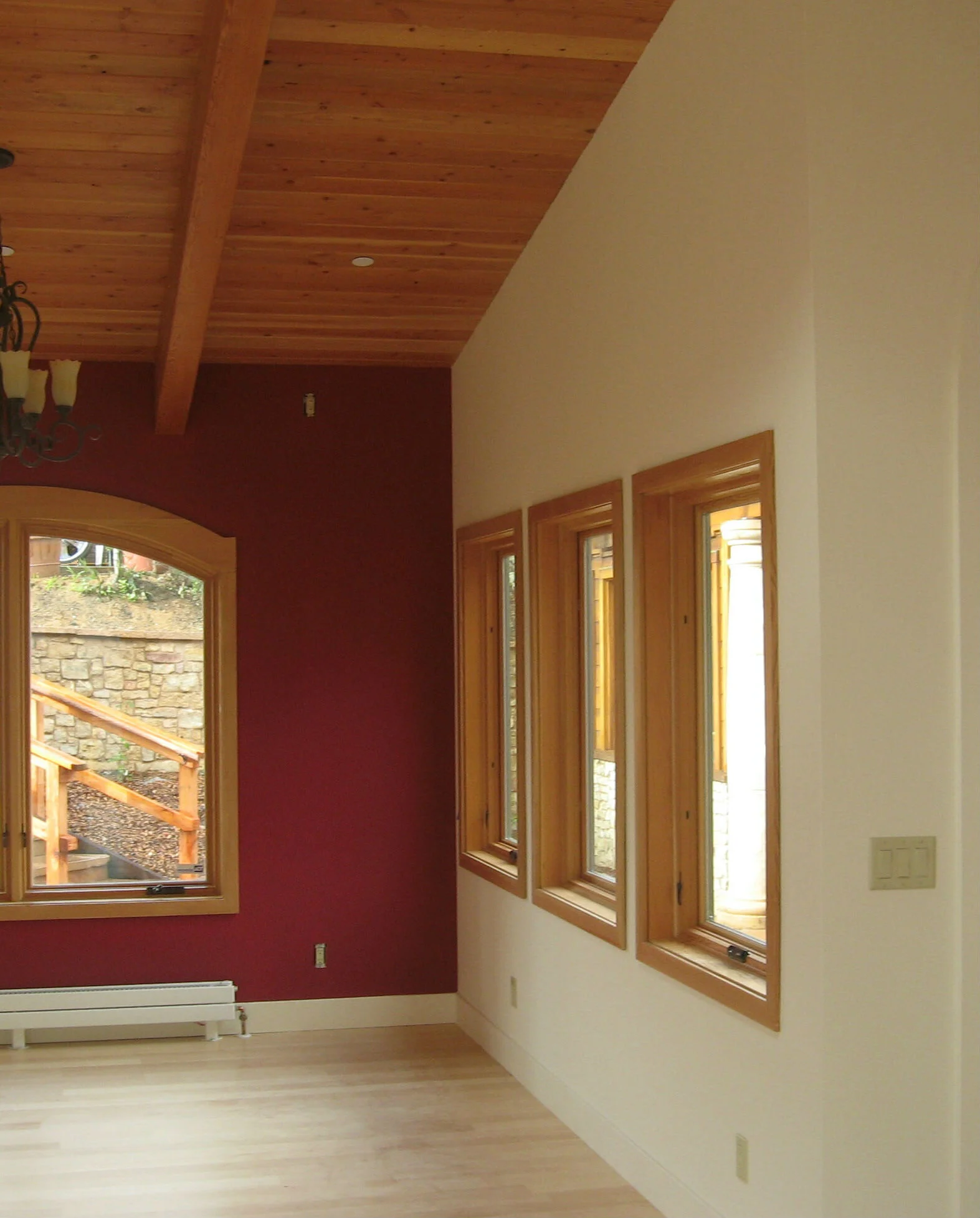 Interior room with multiple colors and natural wood windows and ceiling