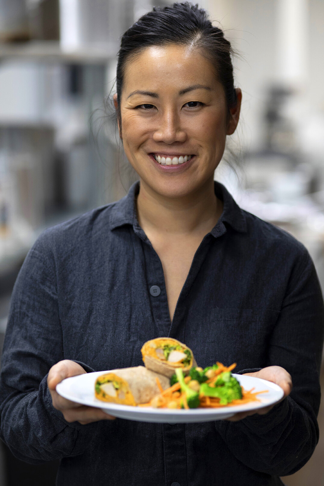 Woman smiling holding plate of food
