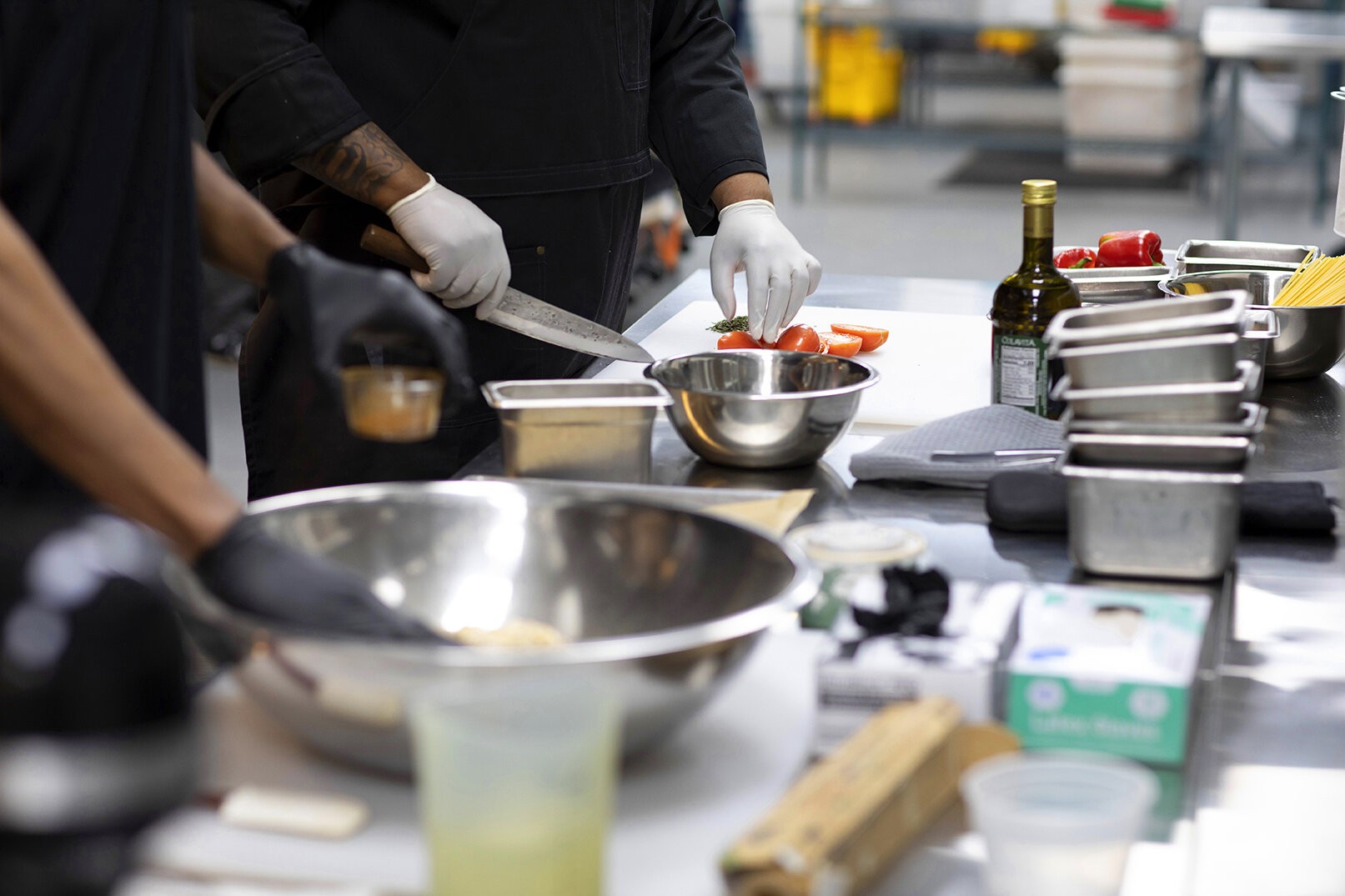 Hand prepping food in bowls on table