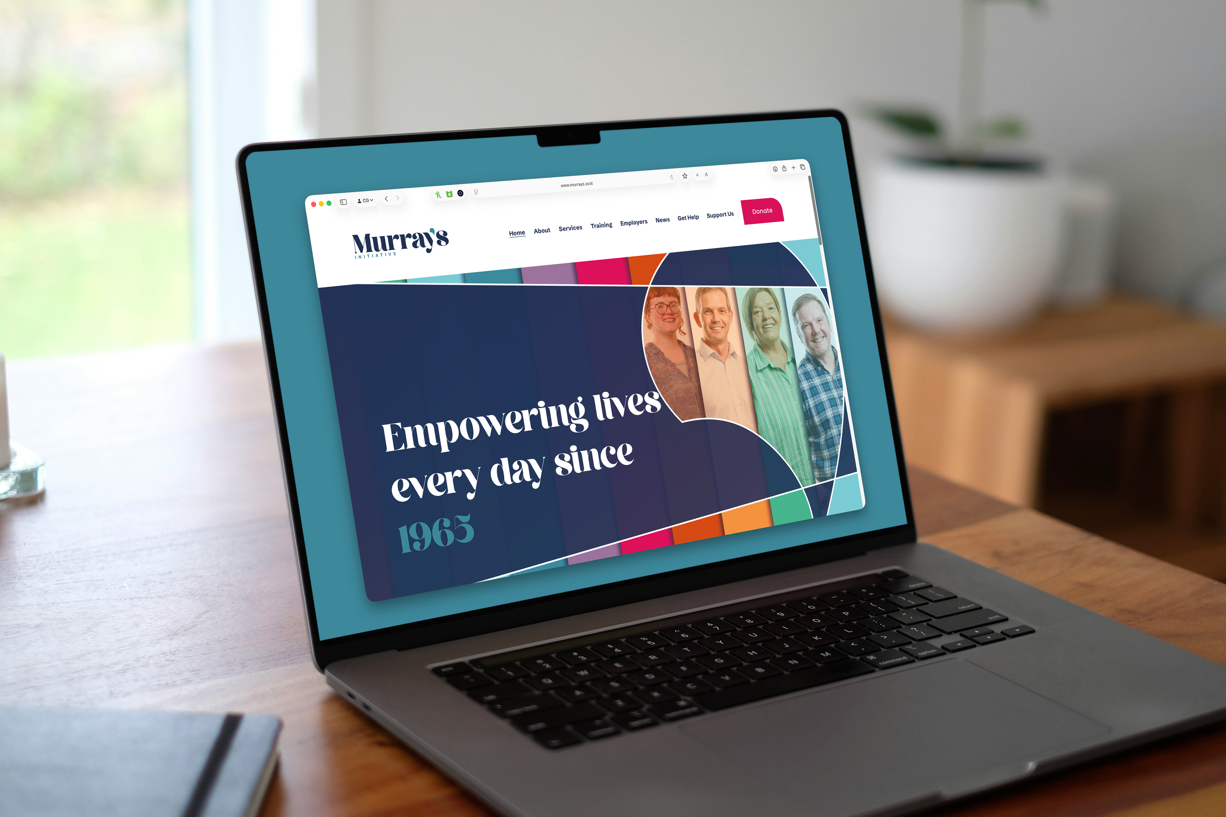 Murray's homepage shown on MacBook in someones office