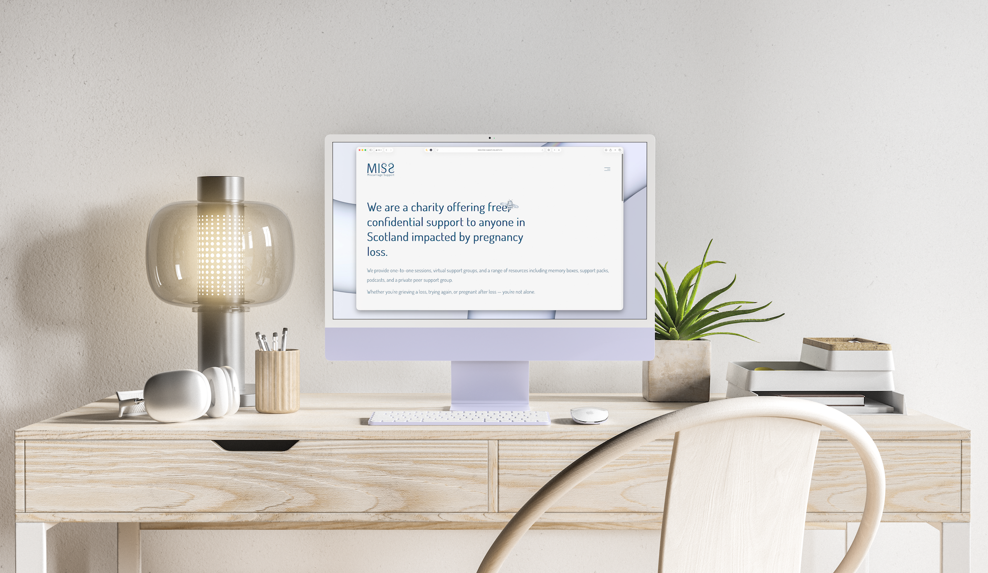 MISS's website displayed on someones work desk