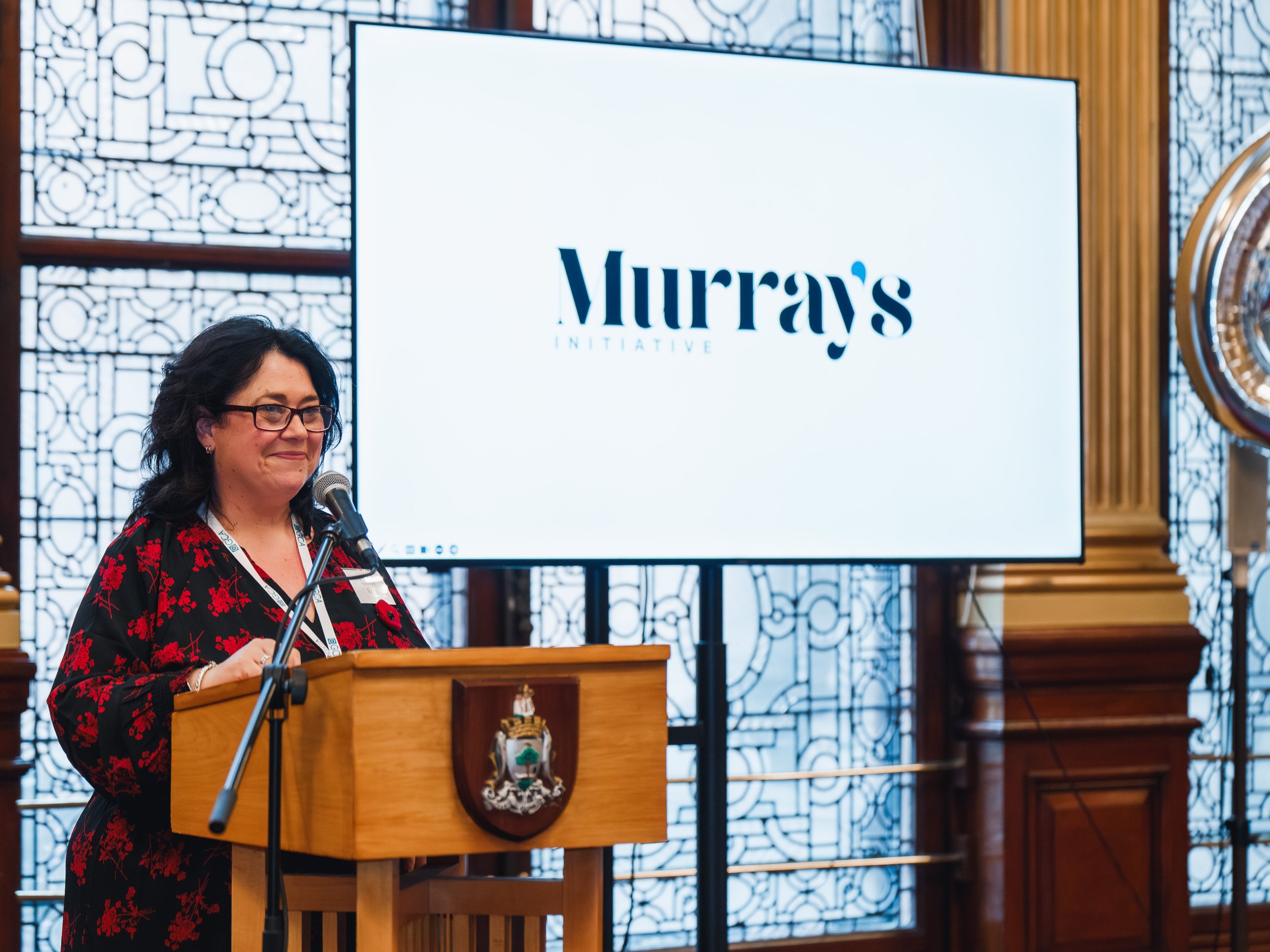Lesley Ross revealing Murray's logo at launch event