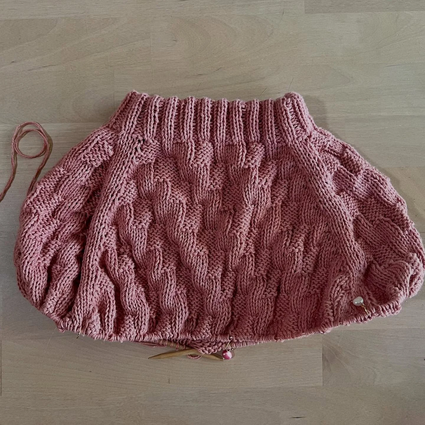 Pink Version of the H.H. Basket Tee underway, ready for sleeve &amp; body separation! 

I adore using these pearl charms (that I make &amp; sell) while I knit - they bring me so much joy as they make their way around the cord to my needles. It&rsquo;