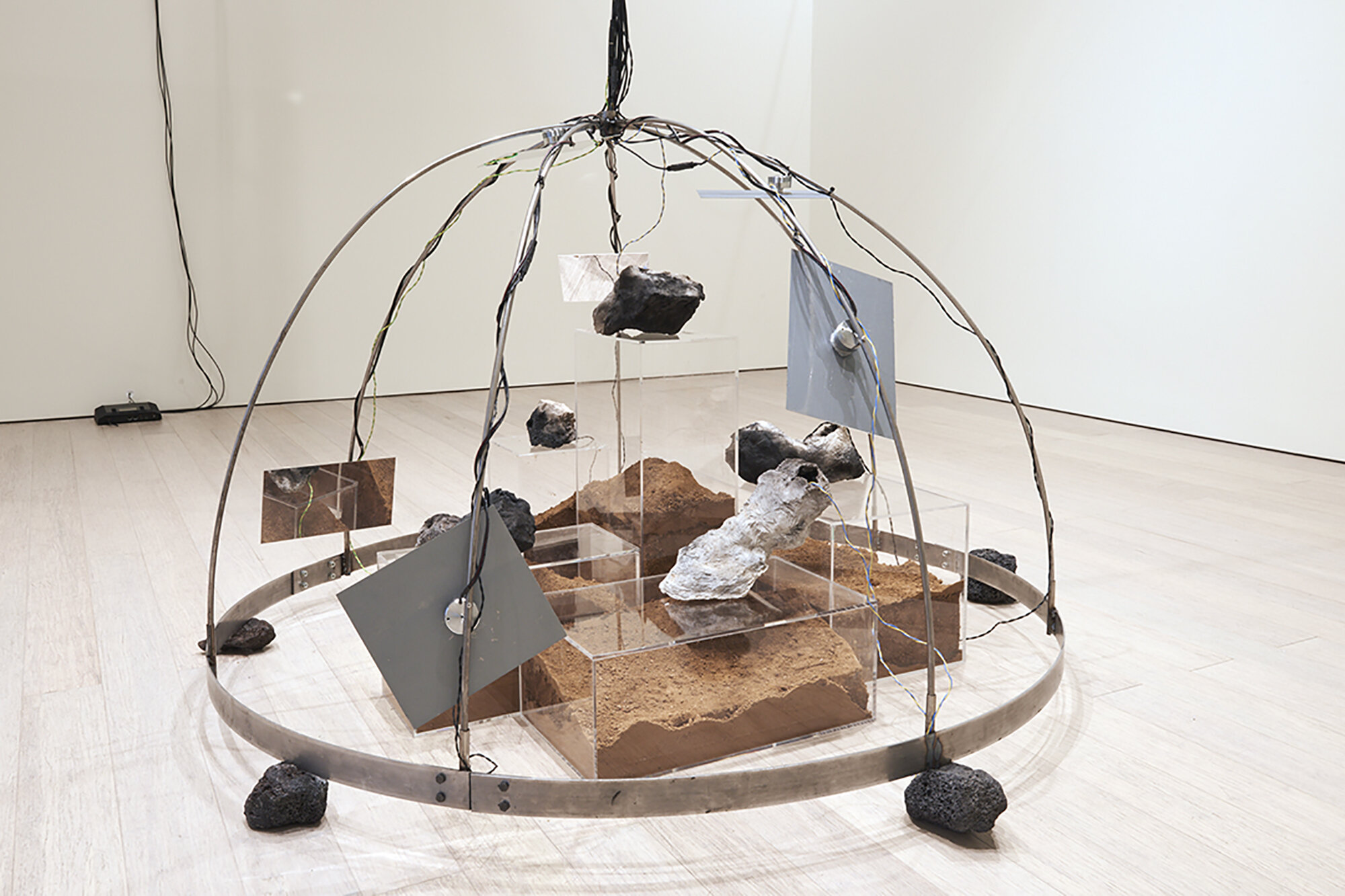  Yixuan Shao and Bicheng Liang  Left Without The Means To Move , (detail) 2021 Lava rocks, anodized aluminum, bone conductors, pit fired wild clay and sound recorded within, desert soil, amplified microphones, speakers, subwoofers, and other mixed me