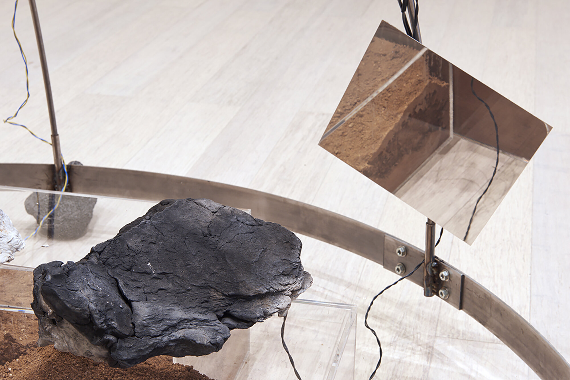  Yixuan Shao and Bicheng Liang  Left Without The Means To Move , (detail) 2021 Lava rocks, anodized aluminum, bone conductors, pit fired wild clay and sound recorded within, desert soil, amplified microphones, speakers, subwoofers, and other mixed me