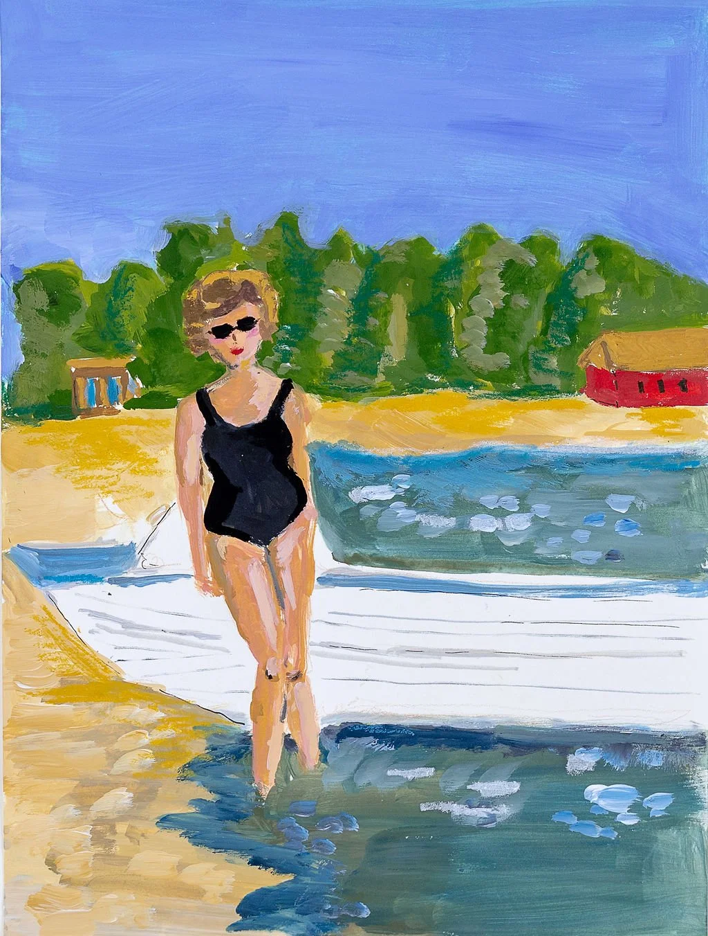 A woman wearing sunglasses in a black swimsuit walking in shallow water at a beach with trees, a red building, and a clear blue sky in the background.