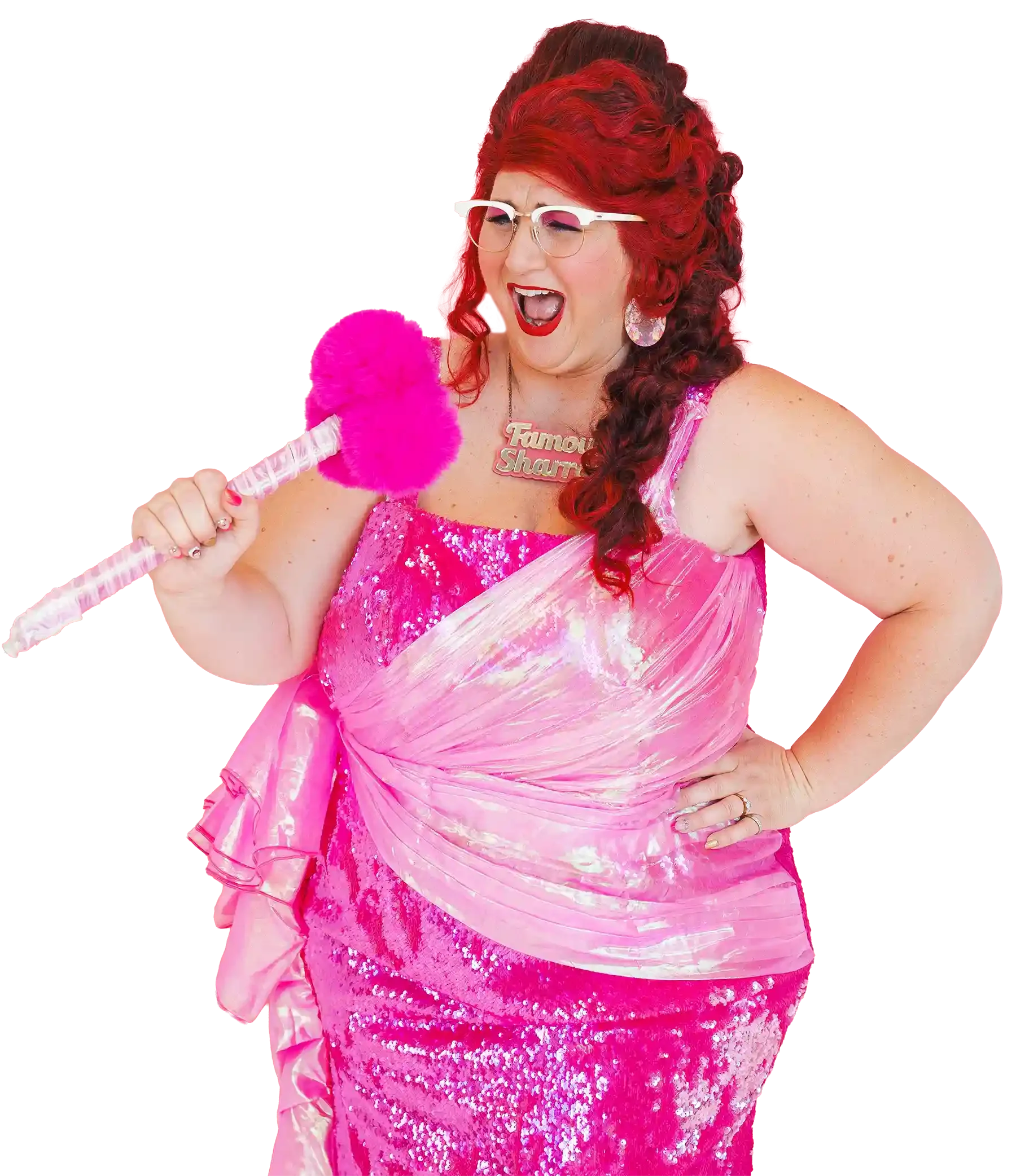 Famous Sharron wearing glasses, a pink sequined dress, large iridescent earrings, and a necklace with the words 'Famous Sharron'. She is holding a pink fluffy feather duster and appears to be shouting or singing.