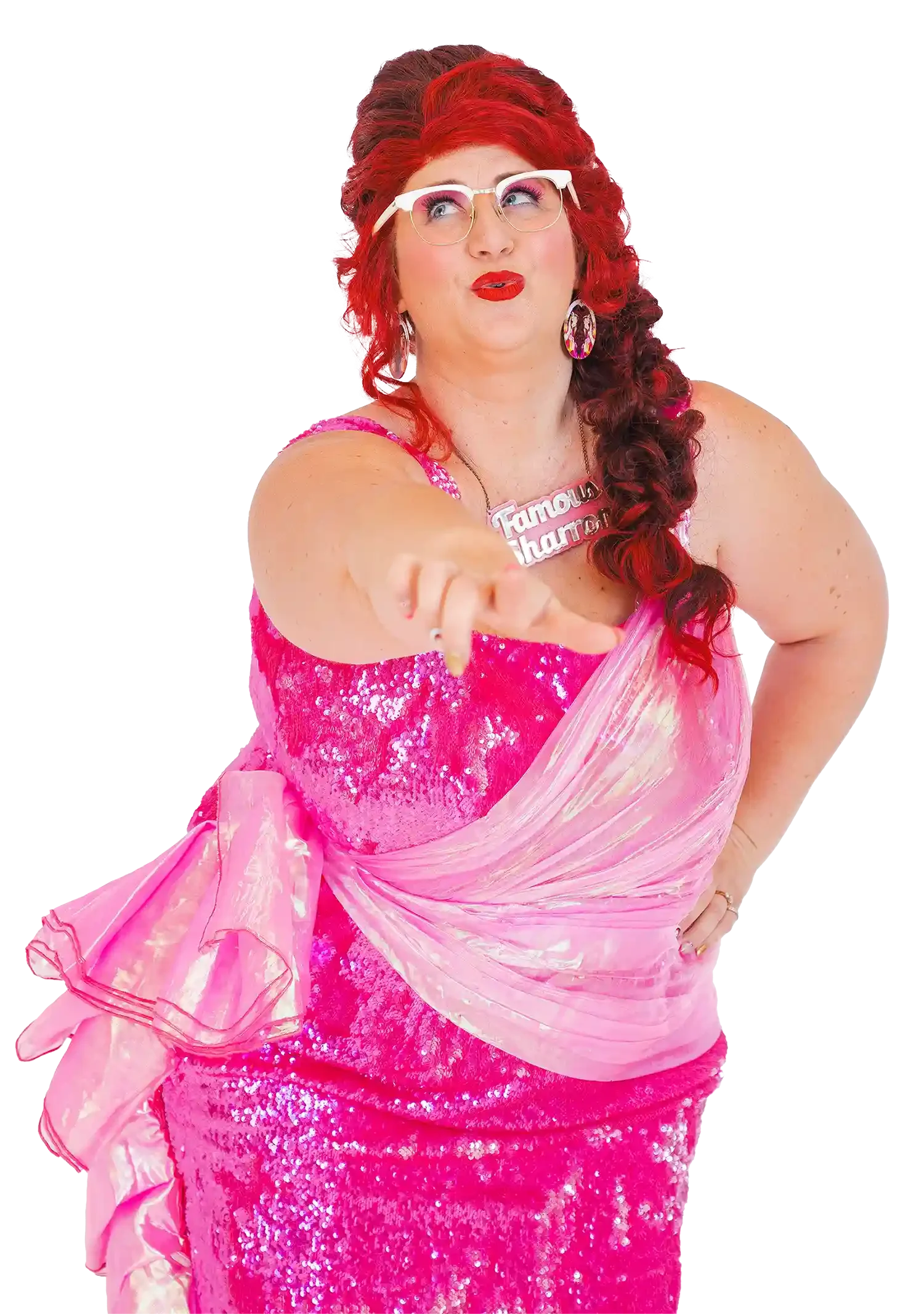 Famous Sharron wearing a pink sequined dress and large earrings, pointing toward the camera.