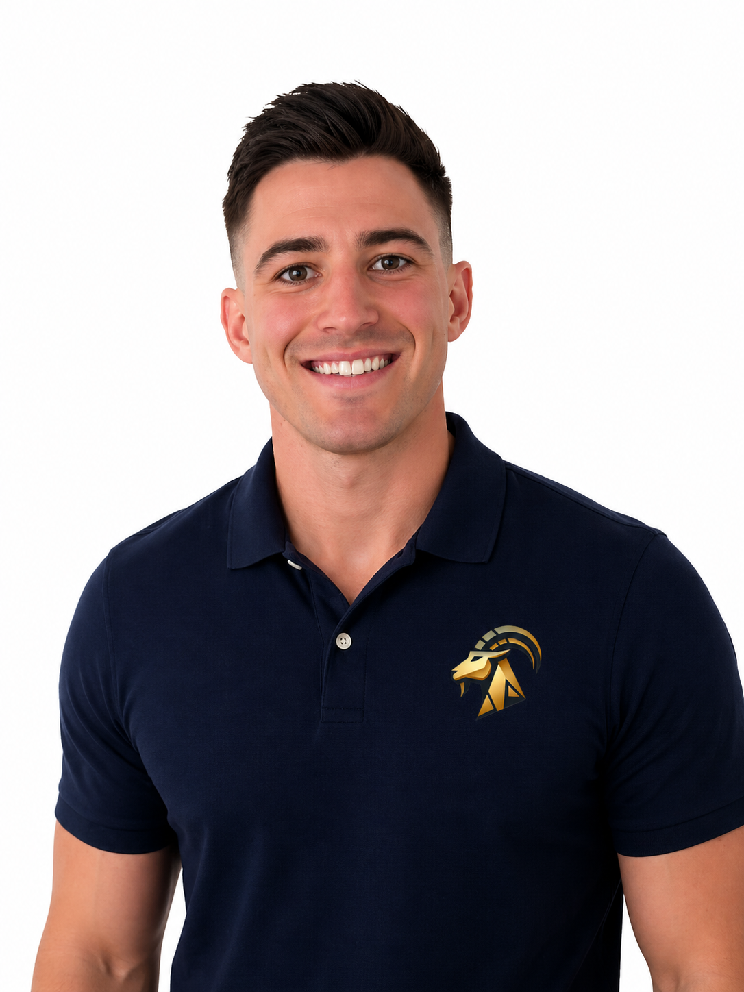 A young man with dark hair, blue eyes, and light skin smiling at the camera, wearing a dark polo shirt with a small logo on the chest, standing against a plain off-white wall.