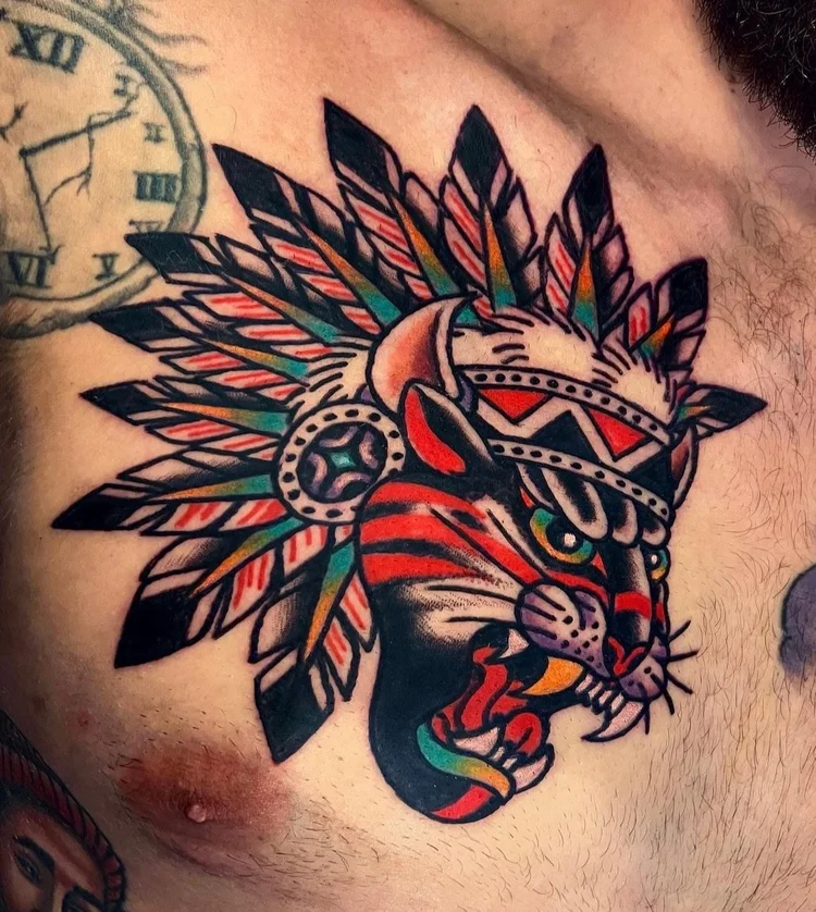 Traditional panther in a feathered headdress chest tattoo by Alex Joelle at Electric Street Tattoo, Fort Lauderdale