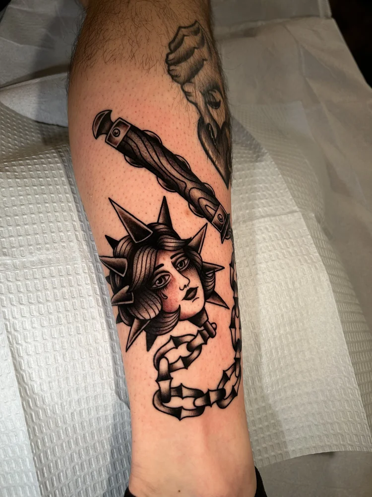 Woman’s head with spyglass and chain tattoo by Lexi at Electric Street Tattoo, Fort Lauderdale