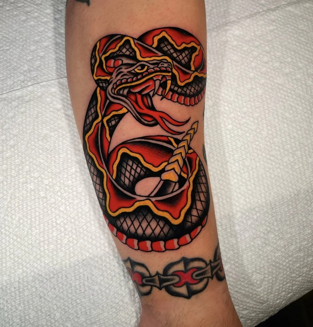 American Traditional coiled snake with chain tattoo by Nick at Electric Street Tattoo, Fort Lauderdale