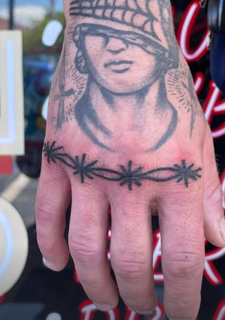 American Traditional woman’s head with barbed wire tattoo on the hand by Josh at Electric Street Tattoo, Fort Lauderdale
