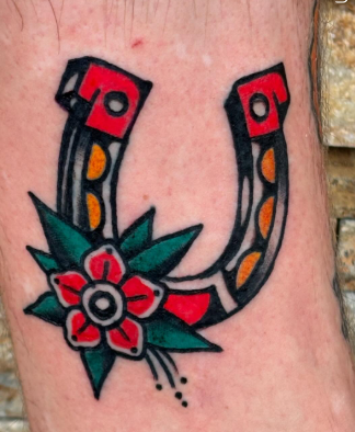 American Traditional horseshoe with flower tattoo by Josh at Electric Street Tattoo, Fort Lauderdale