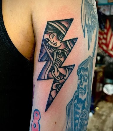 American Traditional lightning bolt with a woman’s face tattoo by Josh at Electric Street Tattoo, Fort Lauderdale