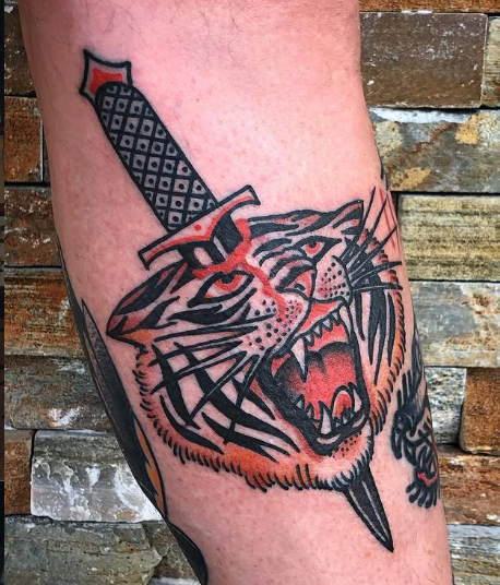 American Traditional dagger through a tiger head tattoo by Josh at Electric Street Tattoo, Fort Lauderdale