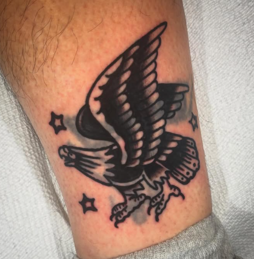 American Traditional black eagle with stars tattoo by Josh at Electric Street Tattoo, Fort Lauderdale