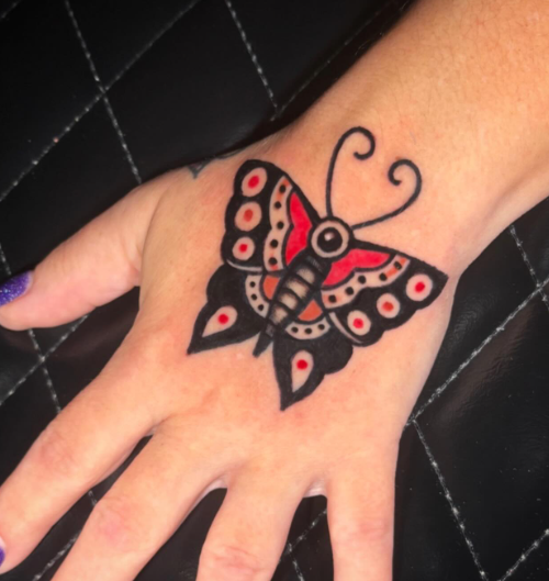 American Traditional butterfly tattoo on the hand by Josh at Electric Street Tattoo, Fort Lauderdale