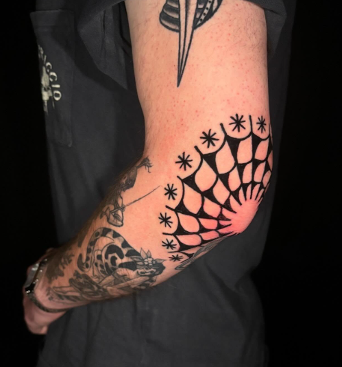 American Traditional spider web tattoo on the elbow by Josh at Electric Street Tattoo, Fort Lauderdale