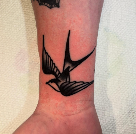 American Traditional swallow tattoo on the wrist by Josh at Electric Street Tattoo, Fort Lauderdale