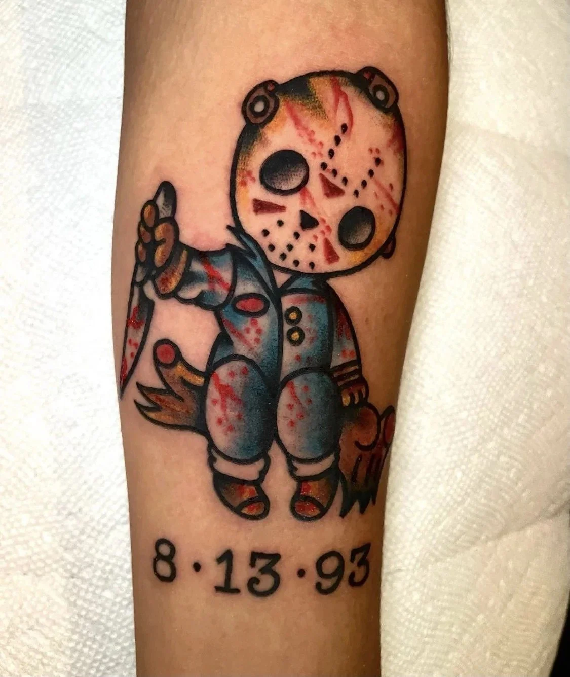 Teddy bear in a Jason Voorhees hockey mask tattoo at Electric Street Tattoo, Fort Lauderdale