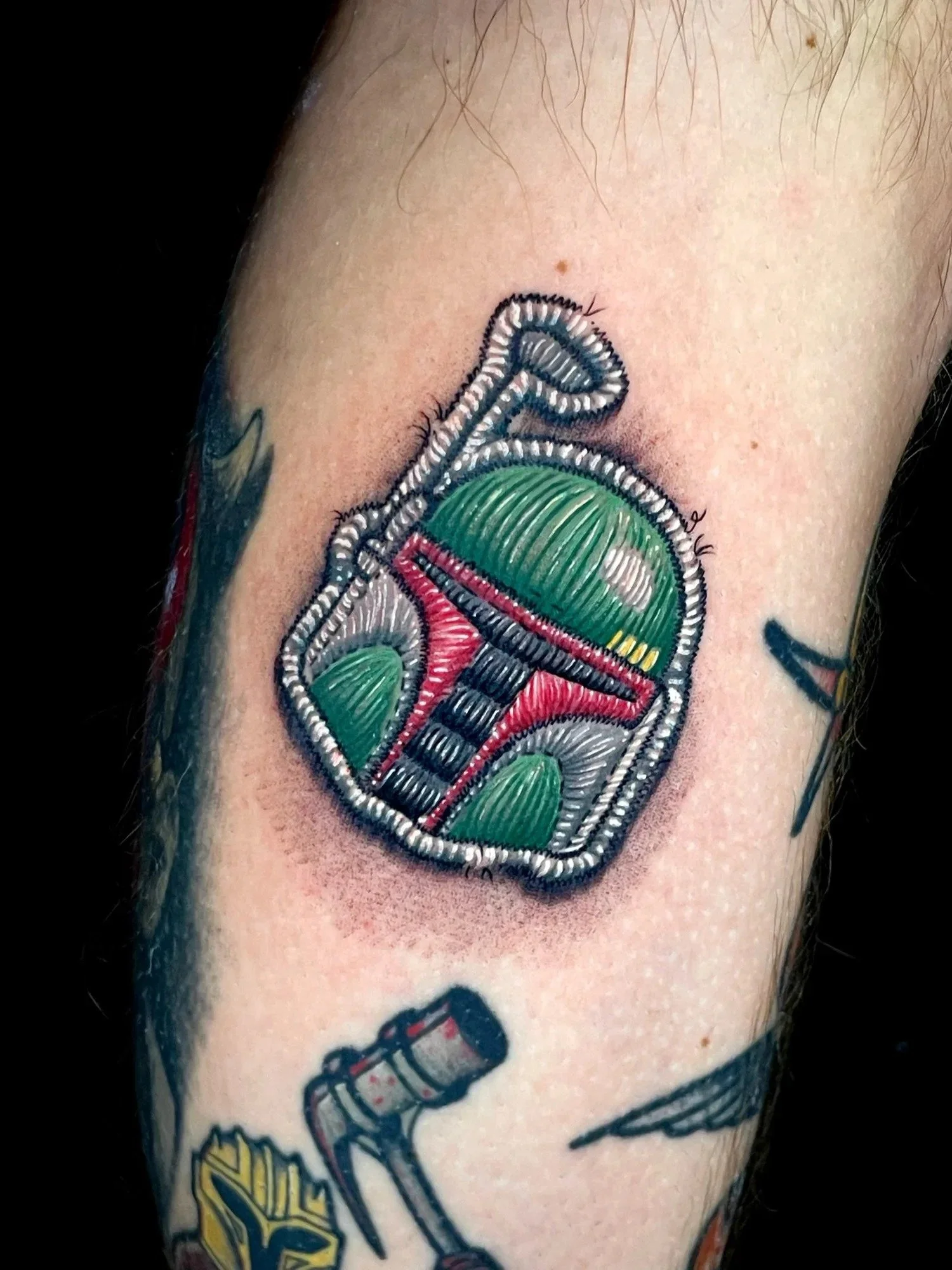 Boba Fett helmet embroidered patch tattoo by CJ Ugarte at Electric Street Tattoo, Fort Lauderdale