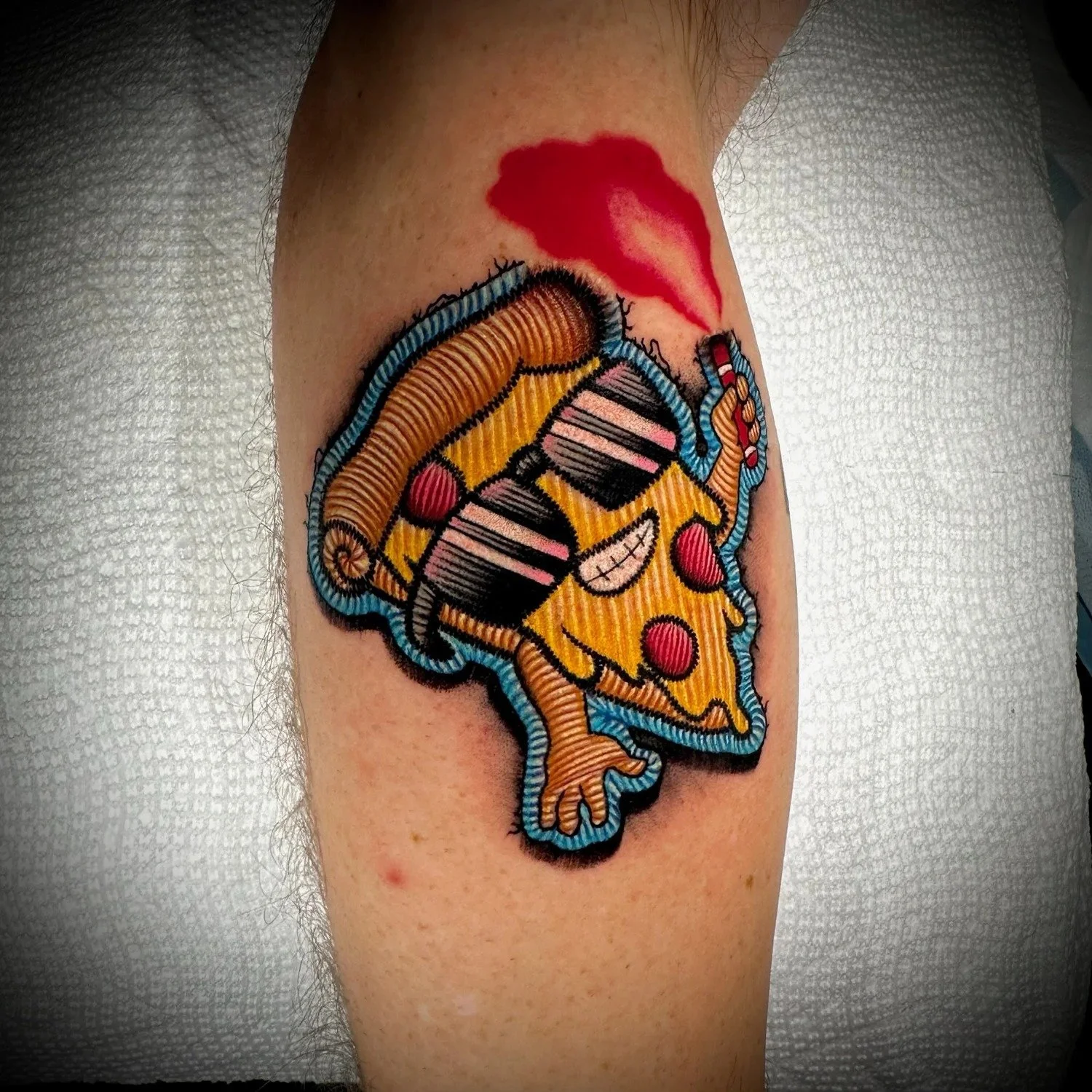 Pizza slice with sunglasses embroidered patch tattoo by CJ Ugarte at Electric Street Tattoo, Fort Lauderdale