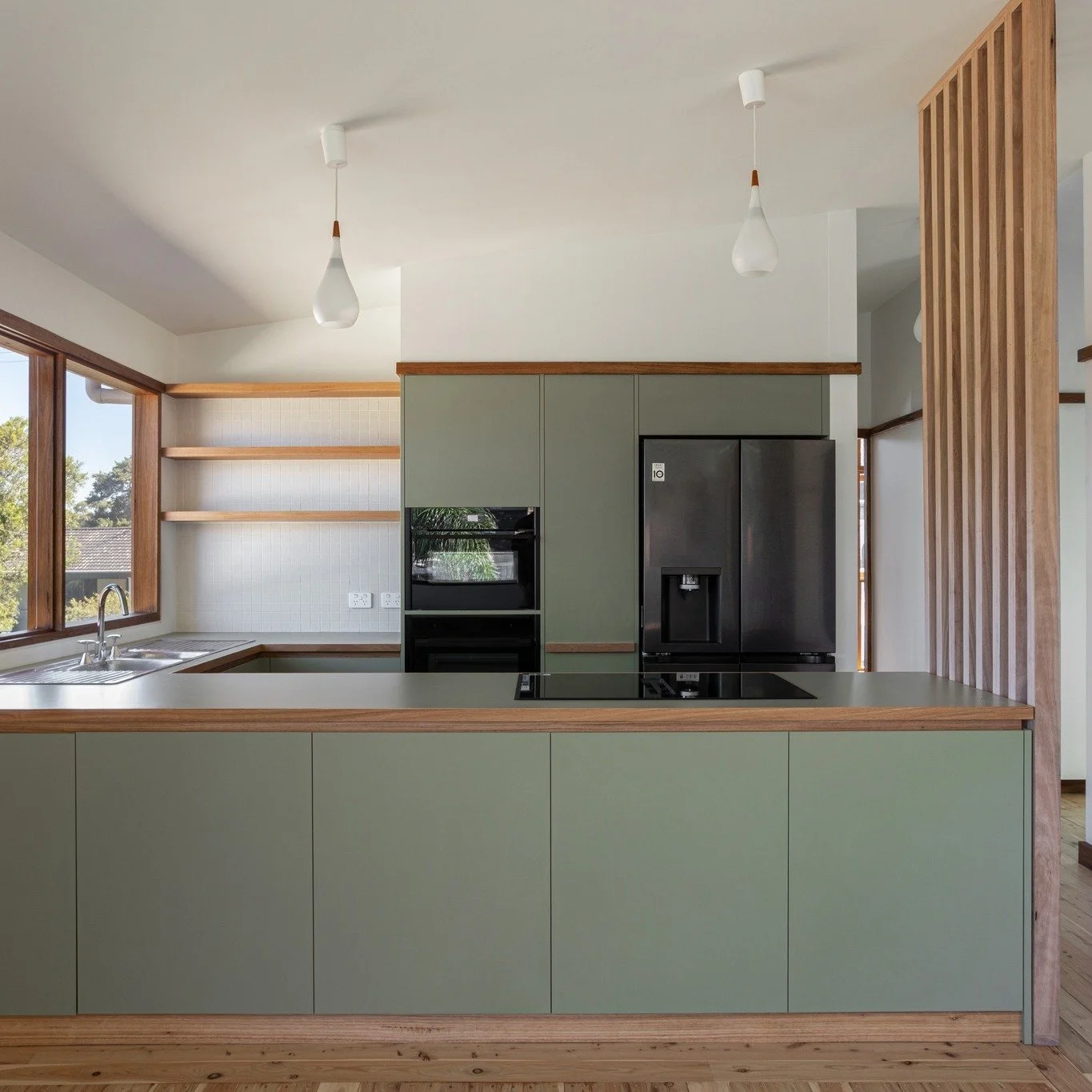 Kitchen. The heart of the Thirroul extension.

Designed with simplicity, warmth, and strong horizontal lines.

Natural light plays across the timber and textured finishes, reinforcing the home&rsquo;s connection to material and craft.

@completeelect