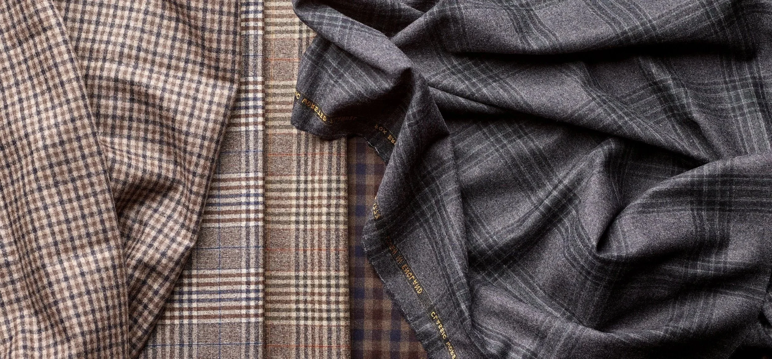 Close-up of three different fabric swatches, all with plaid patterns in shades of brown, beige, and gray.