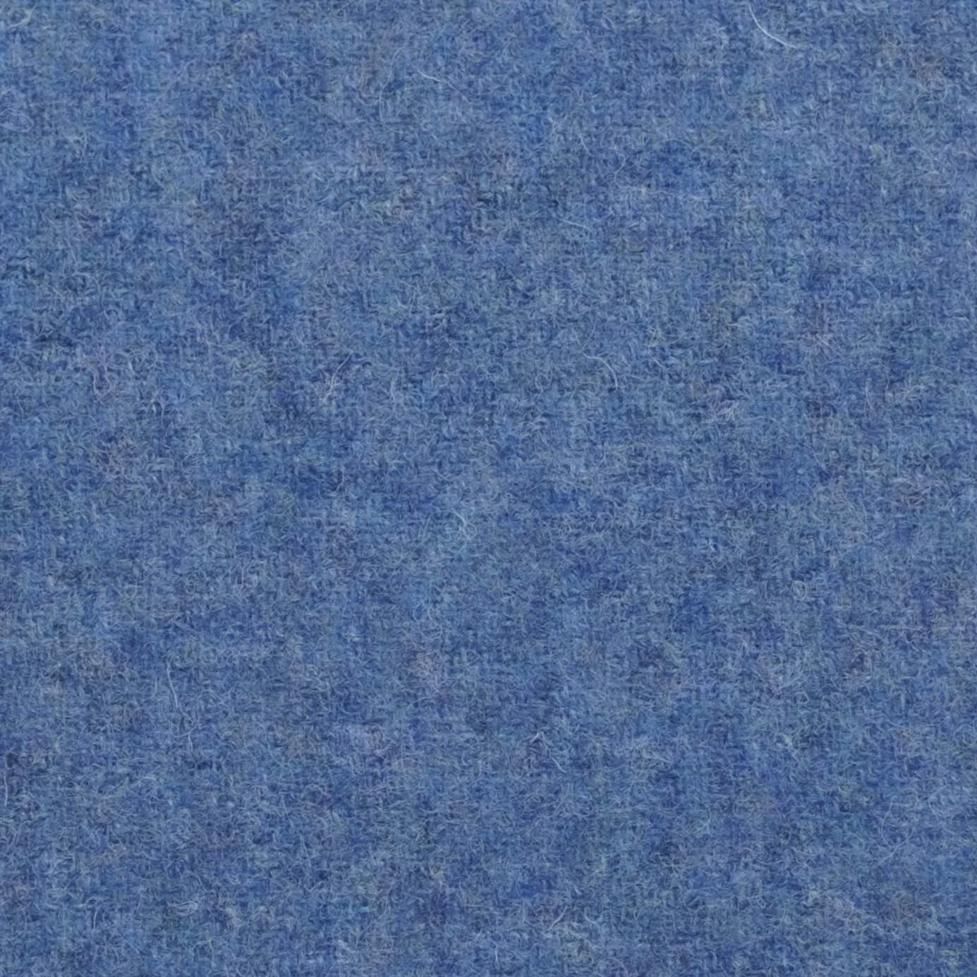 Close-up view of a blue textured surface, possibly fabric or felt