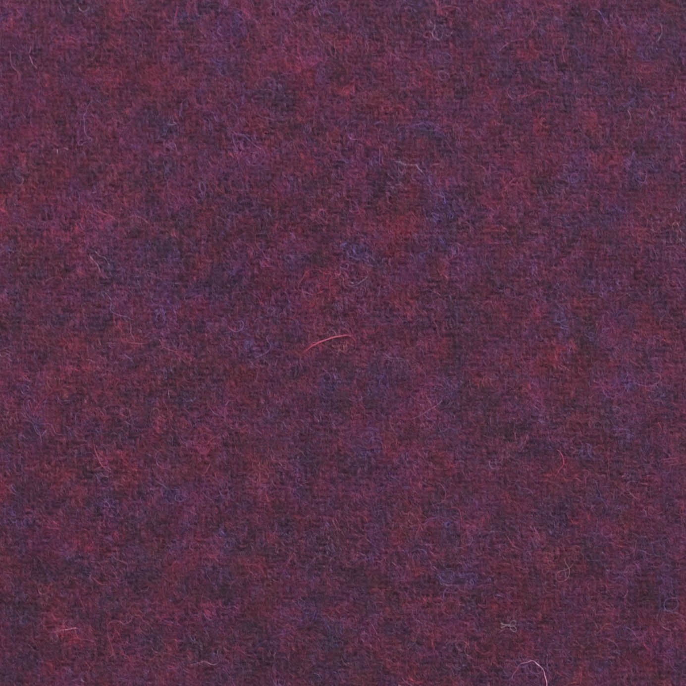 Close-up of a textured burgundy fabric with subtle variations in color and fibers.