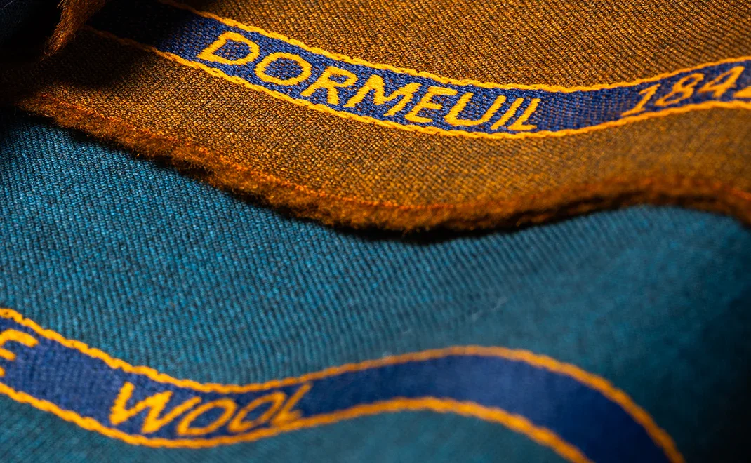 Close-up of a fabric with embroidered text 'DORNEUIL 184'.