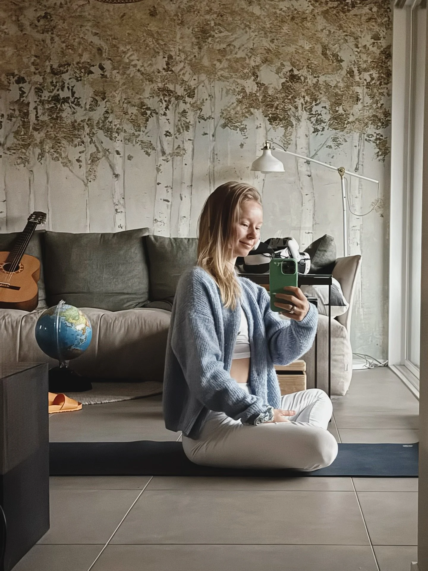Not my usual yoga space but it works.
On the weekends I do my yoga practice right after waking up, and since the rest of the family is still sound asleep, I practice in our living room. I keep one yoga mat, a block, and a strap behind the couch so I 